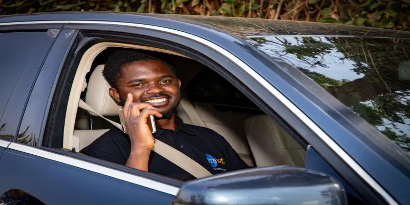 Seth Oluoch poses inside Ultra Bet’s Mercedes Benz